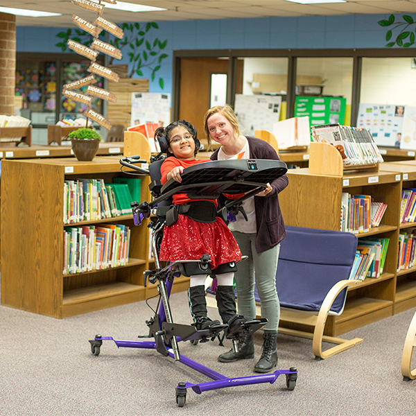 RMS Easystand product benefits A happy children with RMS Easystand product to offer a better range of motion and security to her life